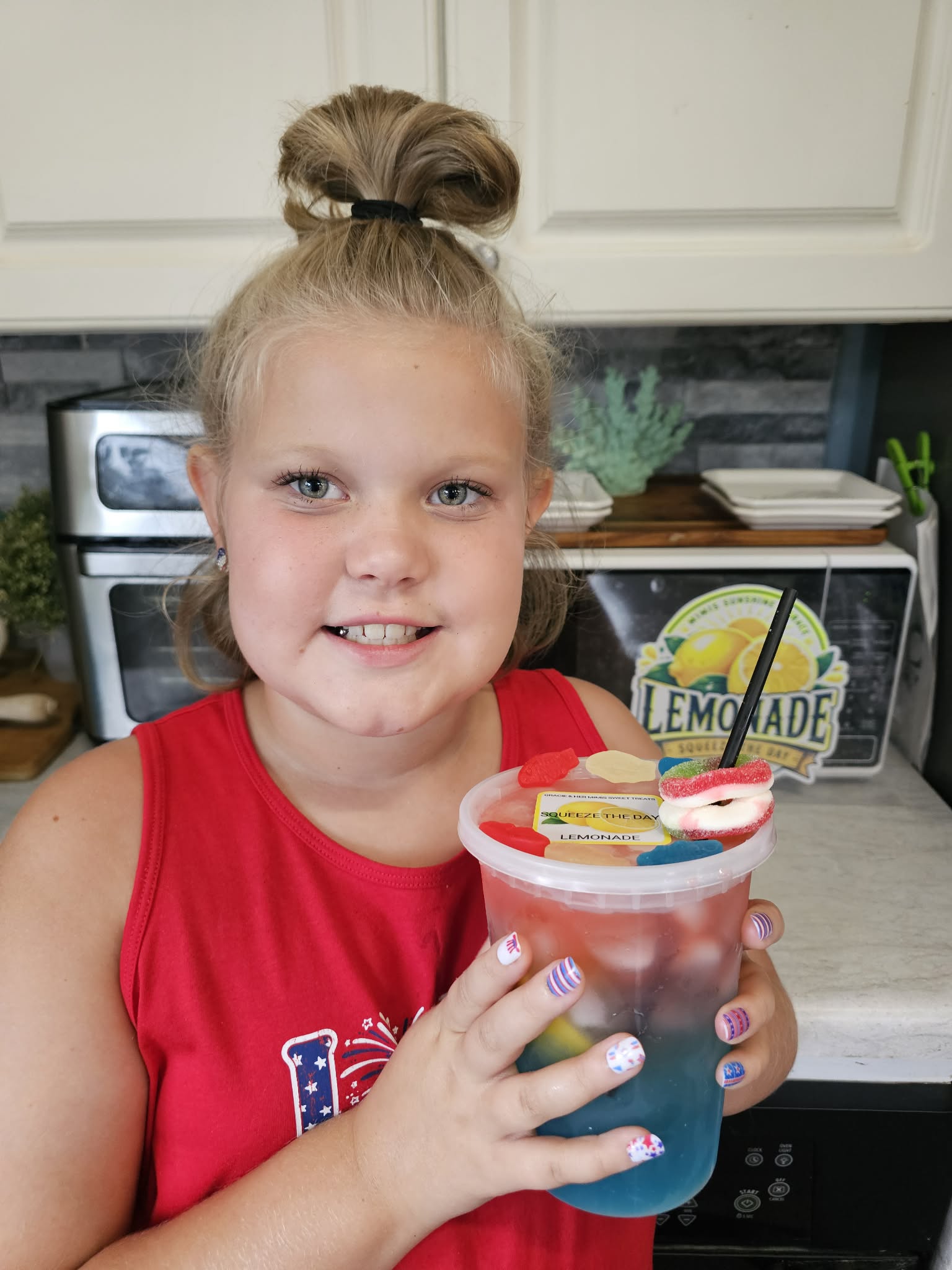 Gracie holding a colorful specialty lemonade